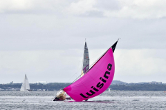 A colourfull spectical in Dun Laoghaire as Eric DrougLazet spinikercomes close to the water at the start of the Third Leg of La Solitaire Du Figaro race   -  Sunday 14th  August 2011 © Michael Chester No Reproduction fee