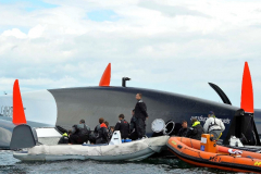 Spindrift winner of the Lisbon to Dun Laoghaire leg crashes out of the La Route des Princes in Dublin bay in style as she capsizes ! members of the crew attend to the injured as reccue boats attend © Michael Chester