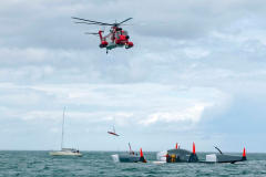 Spindrift winner of the Lisbon to Dun Laoghaire leg crashes out of the La Route des Princes in Dublin bay in style as she capsizes ! Saturday 22nd June 2013 Members of the crew attend to the injured as Air/Sea reccue boats attend as a injured party  Jacques Guichardis airlifted  to Tallaght Hospital © Michael Chester